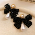 Detail of beaded black bow earrings featuring gold-rimmed and teardrop pearl pendants - 65# Silver Earring Post - Gold - Black - Pearl Bow