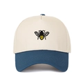 Detailed close-up of bee embroidery on a contrast color canvas baseball cap - Dark Blue