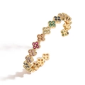 Adjustable golden open bangle with colorful zircon clover charms and polished metal finish - Gold Multicolor Zirconia Clover Bangle