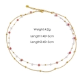 Collana a due strati con perline rosa e ciondolo a delfino su sfondo bianco - Collana di Rodocrosite