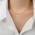 Minimalist gold titanium steel bamboo link necklace worn on model over white shirt - Medium Version / Gold