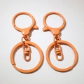 Detail of orange lobster clasp hooks with rotating joints and painted metal rings - Orange (Painted)