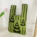 Close-up of green knit tote bag with black geometric patterns and soft texture - Cake Green