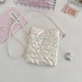Detail of heart-quilted crossbody bag with pearl chain strap, lace and bow accents - Heart Beige