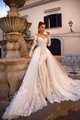 Elegant white lace long sleeve wedding dress with a deep V-neck and grand tulle train - US 2 / White