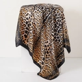 Classic leopard print silk square scarf with wide black border displayed on white cube pedestal - Black Edge Leopard (No.32)