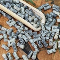 Macro view of 8mm cylindrical ceramic beads with black and white ink splatter texture - Reed Grey (Painted 6x12mm)