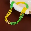 Detail of bohemian layered necklace with green and yellow beads and gold horseshoe clasp - Green Yellow Horseshoe Buckle Beaded Necklace