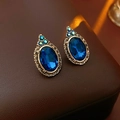 Close-up of vintage earrings featuring large blue faceted gemstones in gold-tone metal frames - 3# Silver Pin Rhinestone Oval Stud Earrings