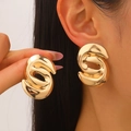Fashionable oversized gold-toned twisted metal hoop earrings with a glossy finish for women - Large Spiral Twisted Irregular Geometric Style / Gold