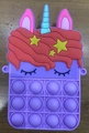 Macro detail of purple unicorn pop fidget toy bag with colorful silicone bubbles - Purple