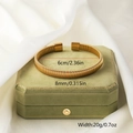 Detail showing the 8mm width and 6cm diameter of this textured gold braided bangle - Gold 5