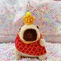 Plush capybara keychain with a yellow crown and red plaid cape on colorful foam balls - Monk Light Brown + Gold Clip