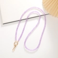 Purple 8mm crystal beaded phone crossbody strap with gold metal clasps on white background - Purple