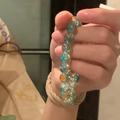 Detailed close-up of faceted blue and amber beads on a handcrafted beaded bracelet - Gradient Crackle Round Beads