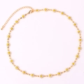 Detailed view of 18K gold plated chain with white and yellow daisy flower charms - White Necklace
