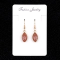 Elegant gold drop earrings with red brown glitter oval stones on jewelry card - Gold Sandstone
