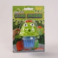 Green monster vomiting slime toy with blue slime in professional retail packaging - Pooping Green Monster 90g