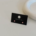 Close-up of minimalist coral pink bead earrings displayed on a black jewelry card - Pink Gold Plated