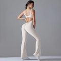 Detailed back view of white yoga jumpsuit featuring hollow-out design and flared leg pants - S / Off-White Grey