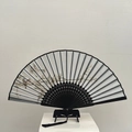 Chinese vintage folding fan featuring plum blossom ink painting and black silk tassel - Blooming Branch (Bamboo)