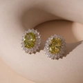 Detailed view of oval yellow zircon stud earrings with silver base and cluster setting - Silver Pin Green Zircon Oval Stud Earrings