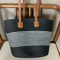 Retro black woven shoulder bag with white stripes and brown handles on a wooden chair - Narrow Stripe Black