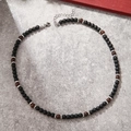Detail of beaded necklace featuring black volcanic stone and brown wooden beads on stone - Black Matte Brown Beads (ZJ10730)