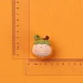 Handmade crochet persimmon doll head charm with size measurements shown on scale - MENGSI Persimmon Dumpling Doll