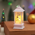 Close-up of white Christmas LED lantern with snowman print on a festive wooden surface - White Snowman