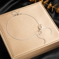 Elegant silver snake chain necklace with a bow tie design on a beige display box - Steel Color (N2749)