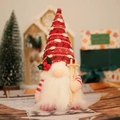 Knitted Christmas gnome doll with LED light and skiing poles on festive background - Red Lighted Gnome / Red