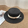 Classic black flat-top straw hat with wide brim and elegant cream satin ribbon band - M / Black with Beige Bow