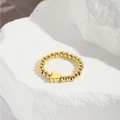 Detail of handmade gold beaded elastic ring with heart charm on white marble stone - Clover Charm Style (ZYN-DMR141G-6)