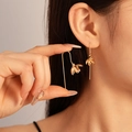 Golden flower petal metal earrings with elegant long drop design worn by a model - Gold Flower Ear Hook (11#)
