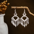 Detail of silver leaf tassel earrings hanging on wood with bohemian ethnic style - Rhombus Frame Leaf Tassel