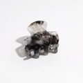 Detail of medium hair claw clip with black and white marble pattern made of acetate - Ink Black and White