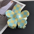 Close-up of a floral-shaped hair claw featuring a vibrant yellow and blue checkerboard pattern - Yellow/Blue Plaid Flower