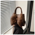 Detail of a brown PU leather crossbody bag with a large padded bow and top handle - Coffee