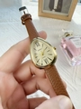 Macro detail of gold snake-head watch with brown leather strap and Roman numerals - Brown Gold Dial (74798)
