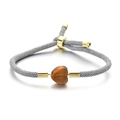 Adjustable woven bracelet featuring a heart-shaped tiger eye stone and gold metal accents - Tiger Eye Heart Style (MLS-0021)