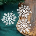 Close-up of three white glitter snowflake ornaments on a rustic wooden tray decoration - 10cm / White