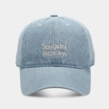 Close-up of white letter embroidery and fabric texture on light blue denim baseball cap - Light Blue