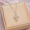 Silver snake pendant necklace with pavé cubic zirconia on wave chain over jewelry box - 6064 Snake Zircon / Silver