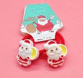 Pair of red Christmas hair ties with Santa Claus charms on festive card packaging - Red Hat Santa