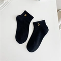 Close-up of black cotton ankle socks featuring delicate golden moon embroidery detailing - Black - Yellow Moon