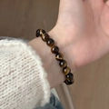 Natural tiger eye stone beaded bracelet with golden brown cat eye effect on wrist - 8mm Grade A Tiger Eye Bracelet