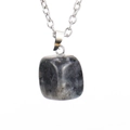 Macro shot of gray natural raw stone pendant necklace with irregular mineral texture - Silver Labradorite