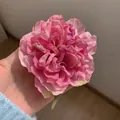 Pink gradient mesh flower hair clip with layered peony petals held in hand - Purple Peony