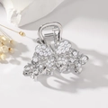 Detailed view of silver butterfly hair claw with white pearls on elegant setup - Pearl Style / Pearl Silver